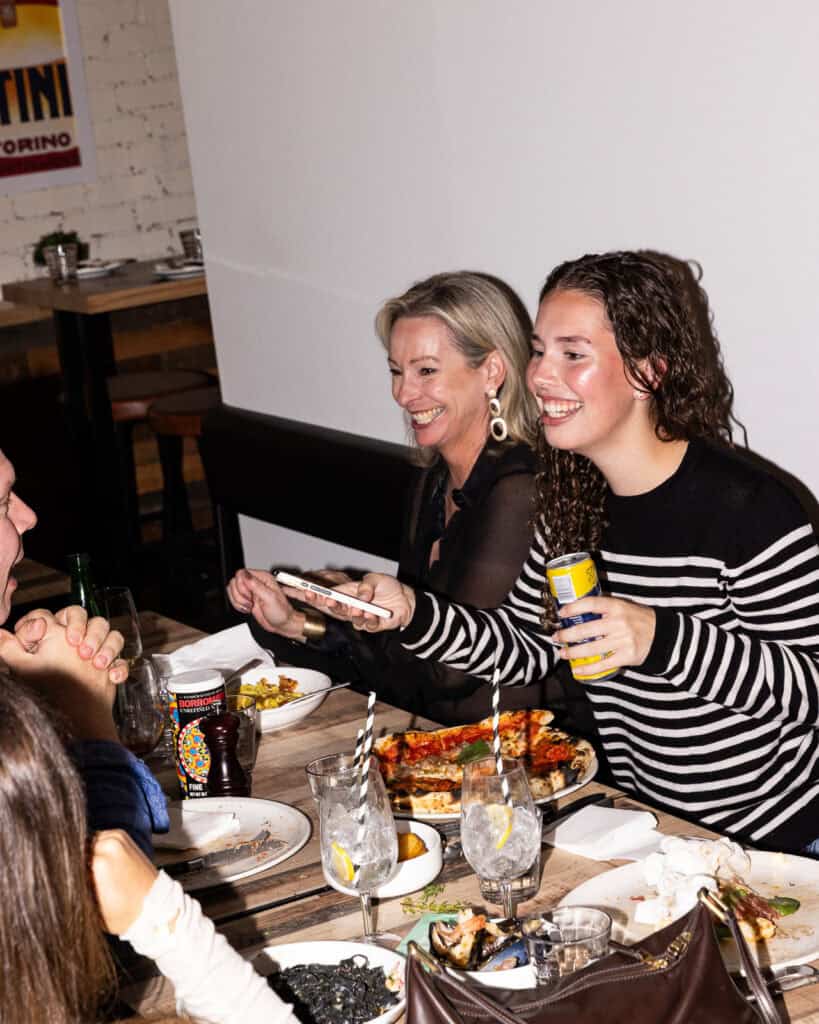 Happy friends dining together at a restaurant