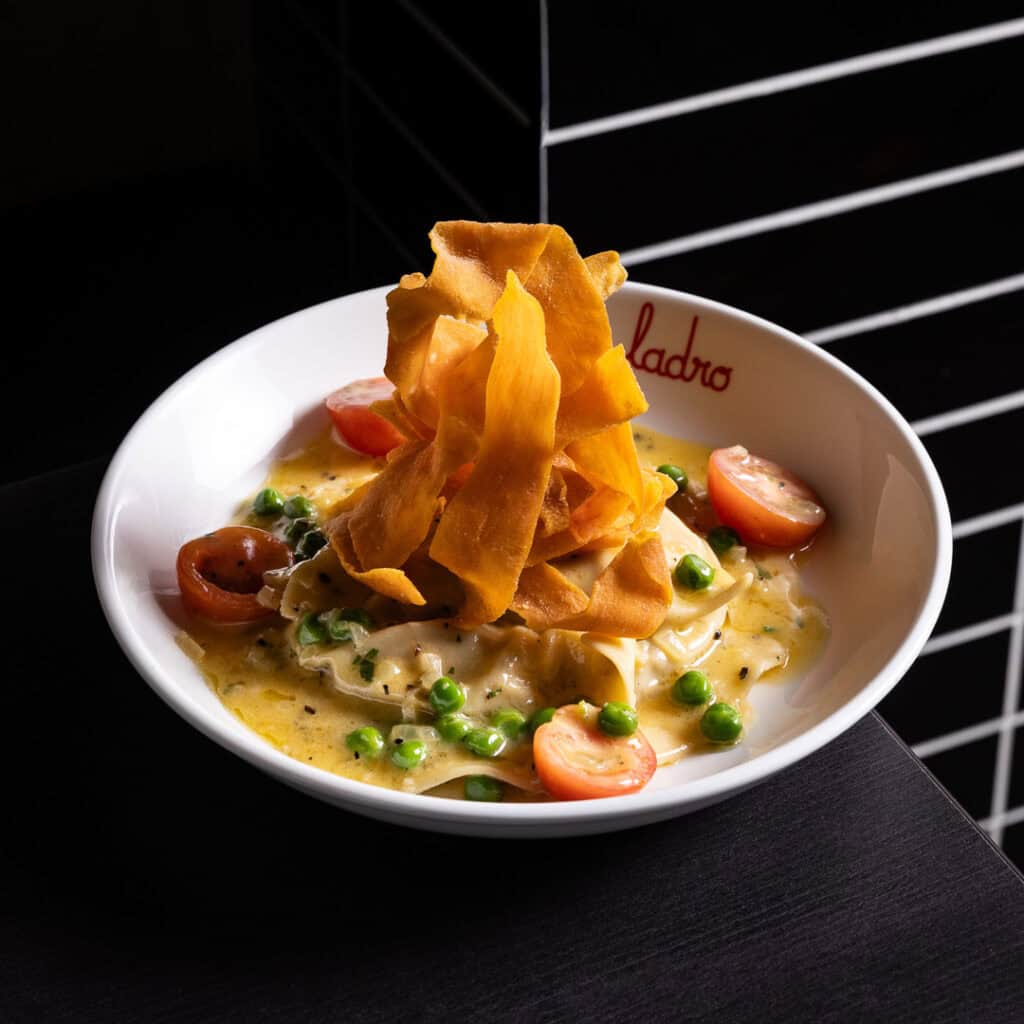 Pasta with creamy sauce, peas, cherry tomatoes.
